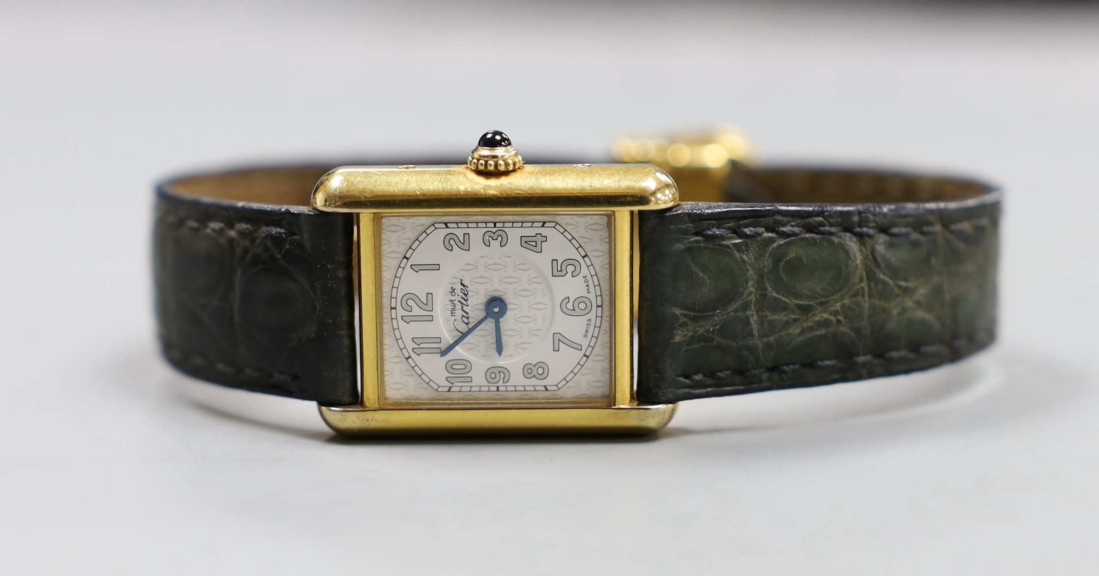 A lady's Must de Cartier silver gilt wristwatch, with quartz movement and blue cabochon winder